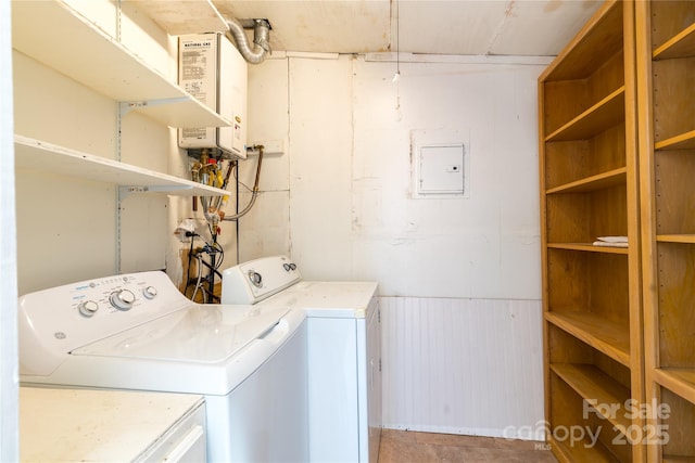 laundry room with tankless water heater, independent washer and dryer, laundry area, and a wainscoted wall
