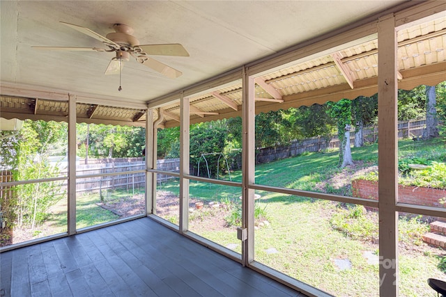 unfurnished sunroom featuring a ceiling fan