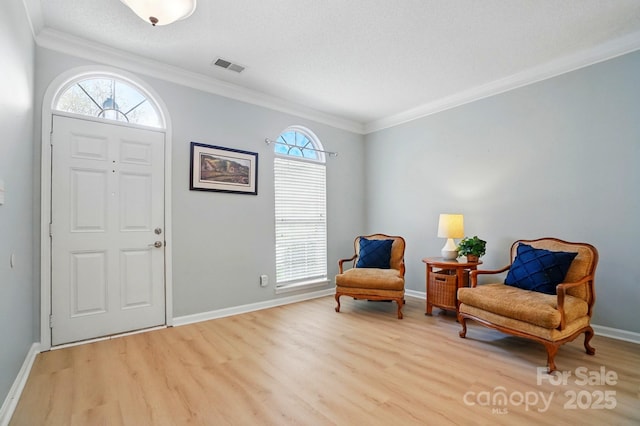 212 Kilborne Rd, Mooresville, NC 28117 - foyer with ornamental molding, visible vents, baseboards, and light wood-style floors