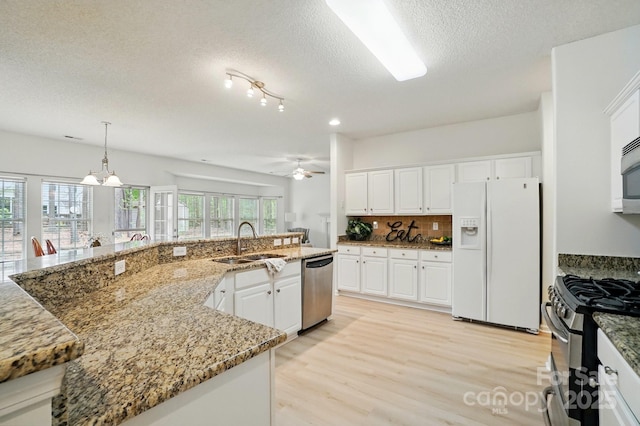 212 Kilborne Rd, Mooresville, NC 28117 - kitchen with a textured ceiling, white cabinets, stainless steel appliances, ceiling fan with notable chandelier, and a sink
