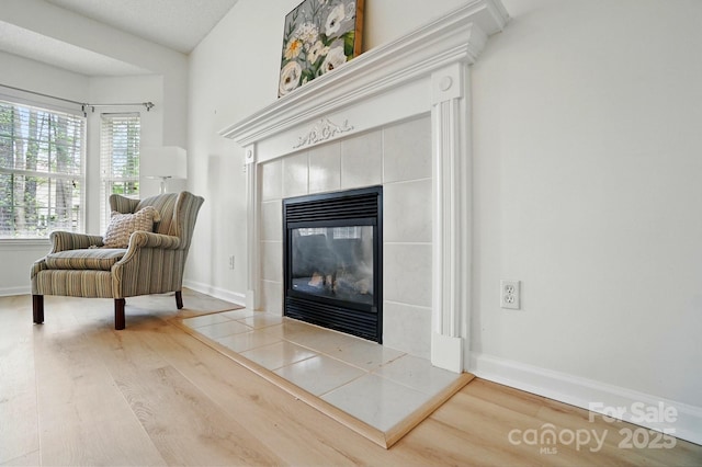 212 Kilborne Rd, Mooresville, NC 28117 - sitting room with a tiled fireplace, baseboards, and wood finished floors