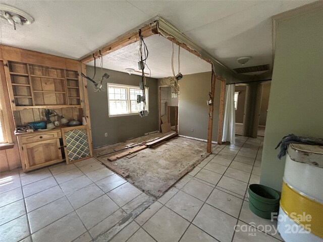 unfurnished dining area with light tile patterned floors