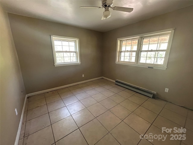 spare room featuring light tile patterned floors, a baseboard radiator, baseboards, and ceiling fan