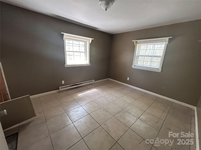unfurnished room with tile patterned floors, a baseboard radiator, and baseboards