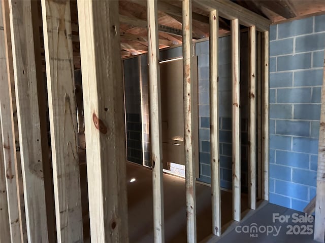 misc room featuring concrete block wall
