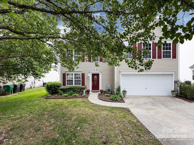 view of front of home with an attached garage, driveway, and a front yard