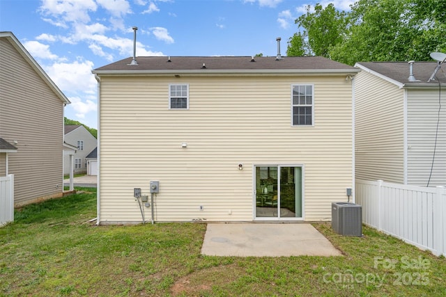 rear view of property with a patio area, central AC unit, fence, and a lawn