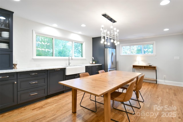 dining area with recessed lighting, plenty of natural light, light wood-style floors, and baseboards
