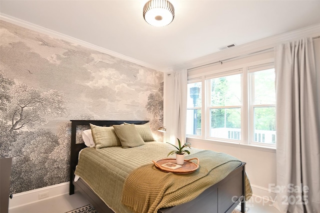 bedroom with visible vents, baseboards, and ornamental molding