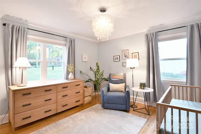 bedroom with crown molding, light wood-style flooring, multiple windows, and a chandelier