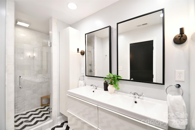 bathroom with visible vents, a sink, a shower stall, double vanity, and recessed lighting