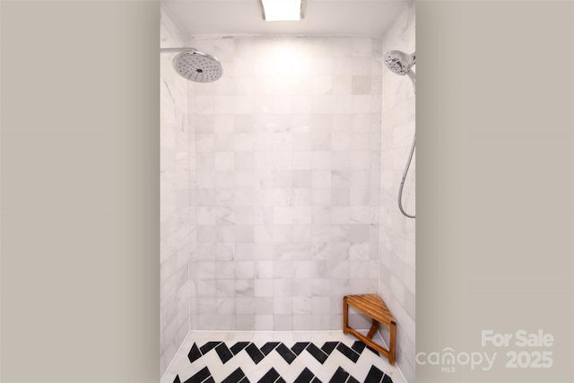 full bath with a tile shower