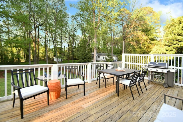 deck with grilling area and outdoor dining space
