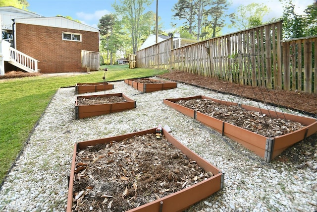 view of yard with fence and a vegetable garden