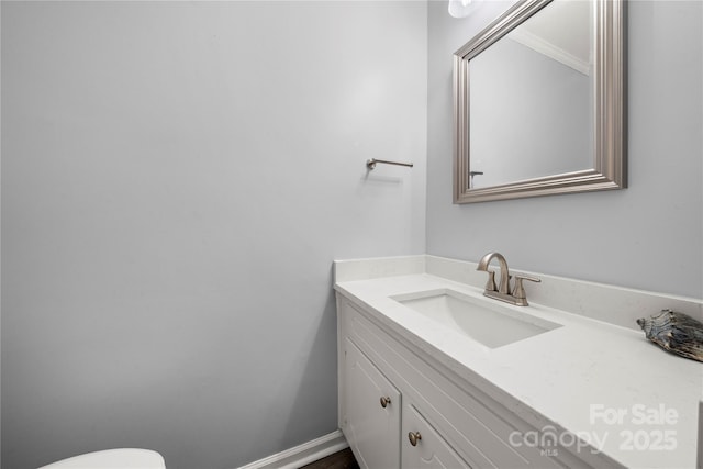 half bathroom featuring toilet and vanity