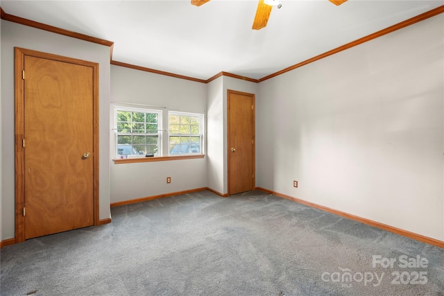 unfurnished bedroom featuring ornamental molding, baseboards, carpet flooring, and ceiling fan