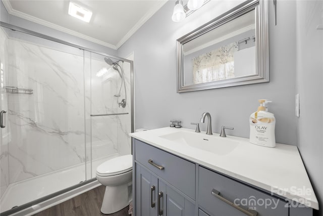 full bath with vanity, ornamental molding, toilet, wood finished floors, and a marble finish shower