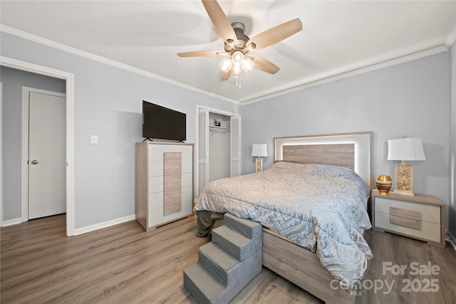bedroom featuring a closet, baseboards, ornamental molding, ceiling fan, and wood finished floors