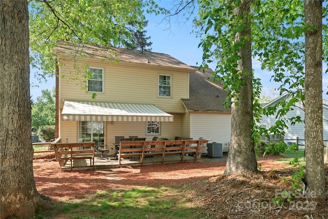 rear view of house featuring central AC and a deck