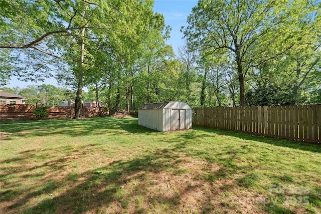 view of yard featuring a storage shed, a fenced backyard, and an outdoor structure