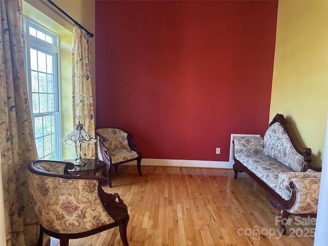 living area featuring wood finished floors and baseboards