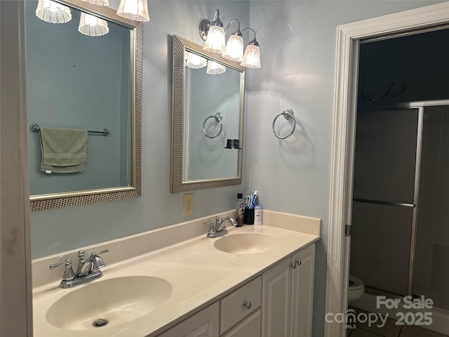 full bathroom featuring toilet, a stall shower, and a sink