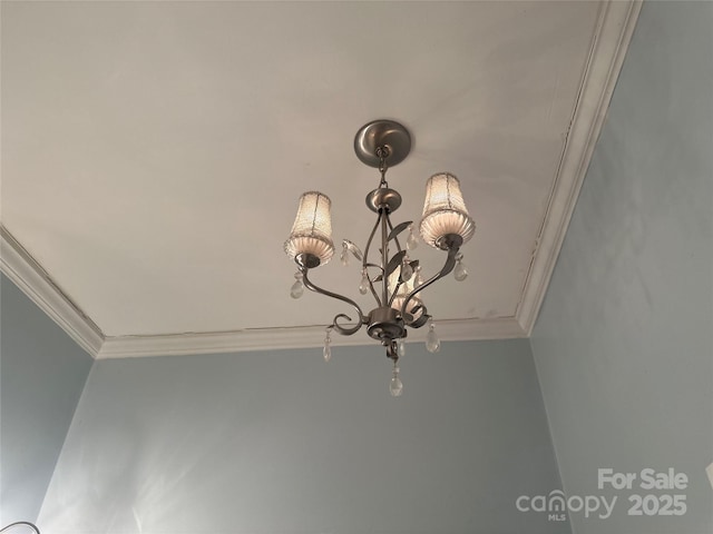 room details featuring crown molding and a chandelier