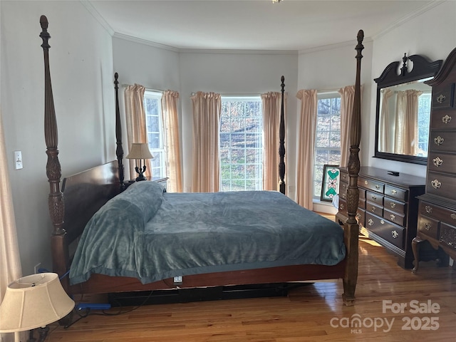 bedroom featuring wood finished floors and ornamental molding