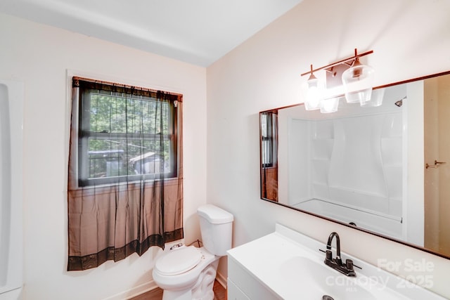 bathroom with a shower, vanity, and toilet