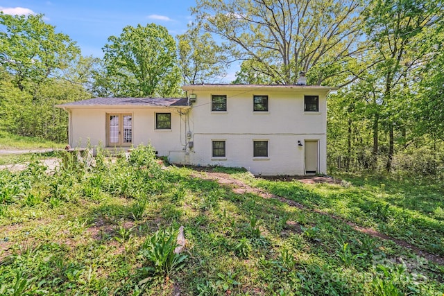 back of property with brick siding and a chimney