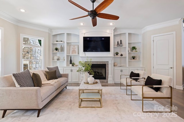 133 Crooked Branch Way, Troutman, NC 28166 - living room with ornamental molding, ceiling fan, built in features, and a fireplace