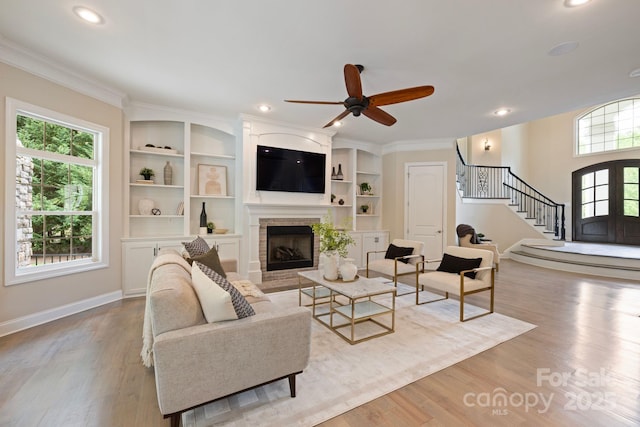 133 Crooked Branch Way, Troutman, NC 28166 - living room featuring stairs, a ceiling fan, wood finished floors, and a fireplace
