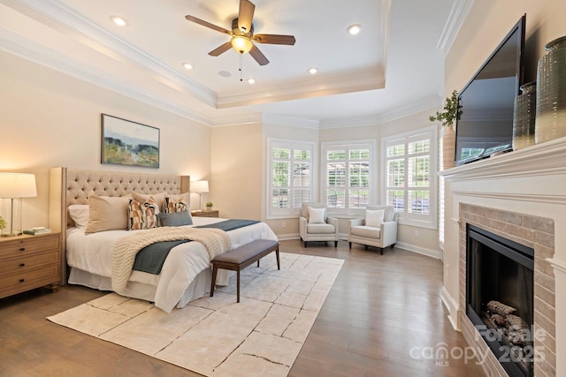 133 Crooked Branch Way, Troutman, NC 28166 - bedroom with a raised ceiling, baseboards, recessed lighting, a fireplace, and wood finished floors