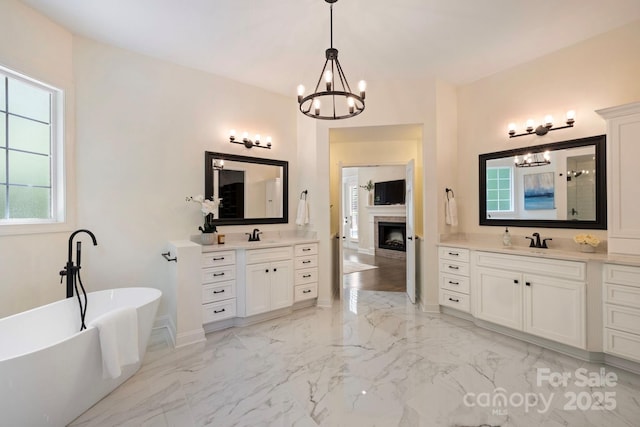 133 Crooked Branch Way, Troutman, NC 28166 - bathroom with marble finish floor, two vanities, a sink, and a chandelier