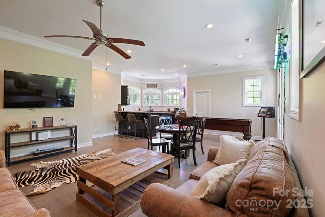 133 Crooked Branch Way, Troutman, NC 28166 - living area with wood finished floors, plenty of natural light, and ornamental molding