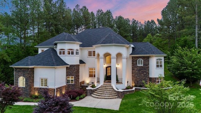 133 Crooked Branch Way, Troutman, NC 28166 - french provincial home with a shingled roof, stucco siding, a front yard, and stone siding