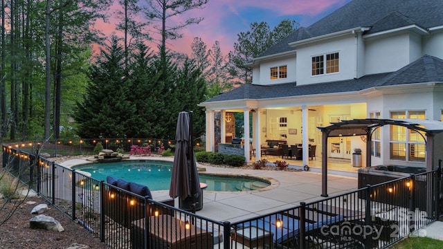133 Crooked Branch Way, Troutman, NC 28166 - pool at dusk with an outdoor living space, a fenced backyard, a fenced in pool, a patio, and a pergola