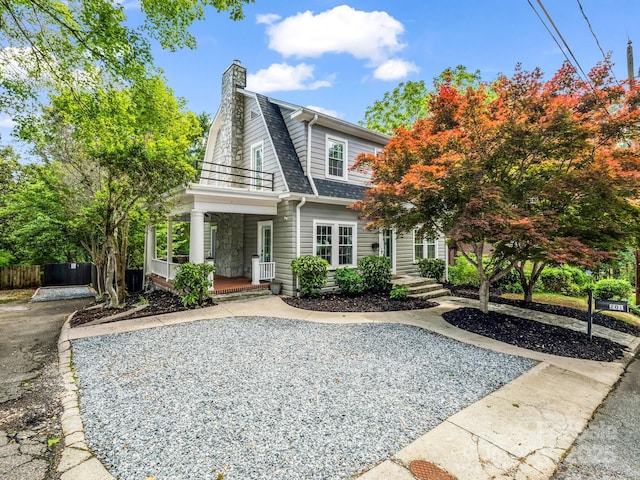 201 W 6th St, Rutherfordton, NC 28139 - colonial inspired home with a porch, a shingled roof, a chimney, a balcony, and fence