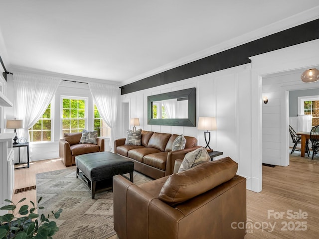 201 W 6th St, Rutherfordton, NC 28139 - living area with crown molding, light wood-style floors, and a decorative wall
