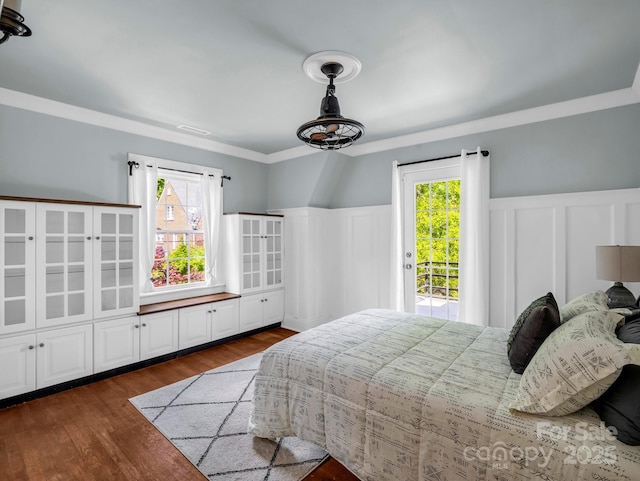 201 W 6th St, Rutherfordton, NC 28139 - bedroom featuring access to outside, a decorative wall, multiple windows, a wainscoted wall, and dark wood finished floors