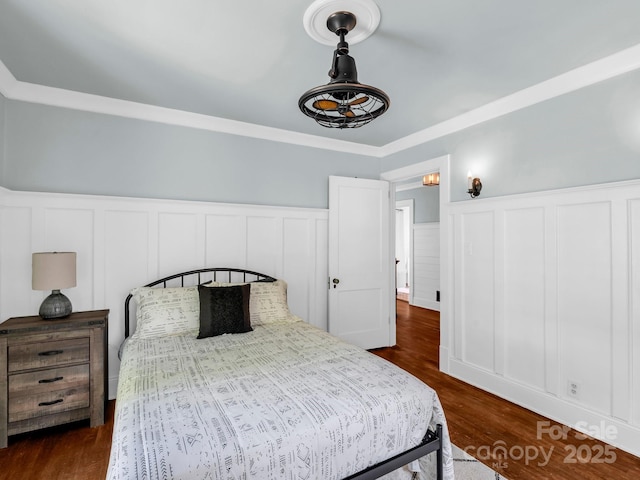 201 W 6th St, Rutherfordton, NC 28139 - bedroom with a wainscoted wall, a decorative wall, dark wood-type flooring, and ornamental molding
