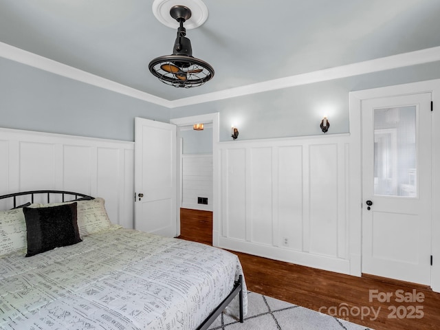 201 W 6th St, Rutherfordton, NC 28139 - bedroom featuring a wainscoted wall, wood finished floors, and a decorative wall