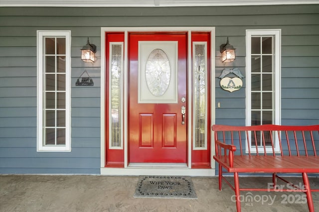 view of exterior entry with covered porch