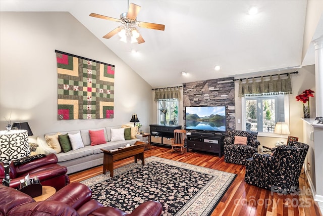 living area with a healthy amount of sunlight, high vaulted ceiling, ceiling fan, and wood finished floors