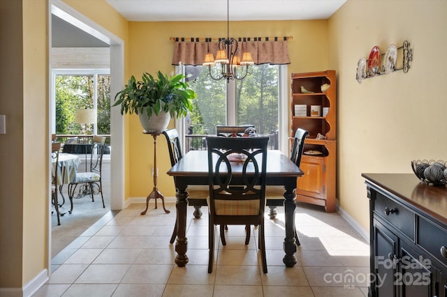 dining room with baseboards and a notable chandelier