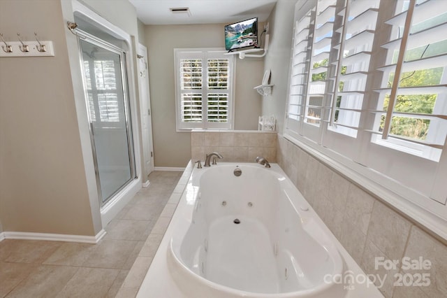 full bath with visible vents, a healthy amount of sunlight, and a jetted tub