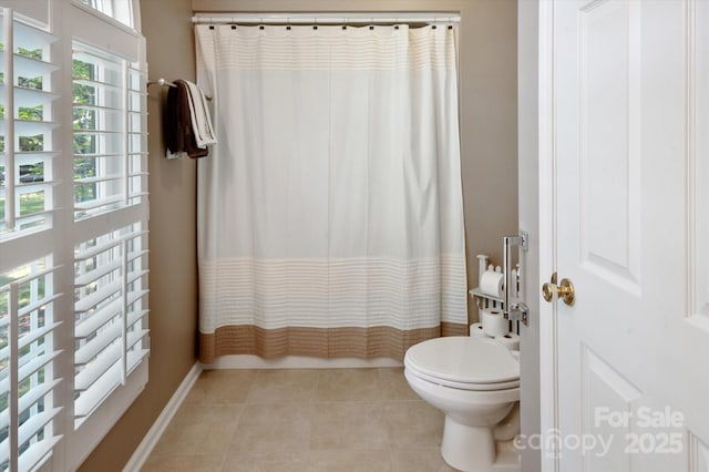 full bath with baseboards, tile patterned floors, and toilet