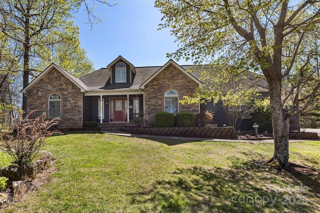 view of front of home featuring a porch, stone siding, and a front lawn