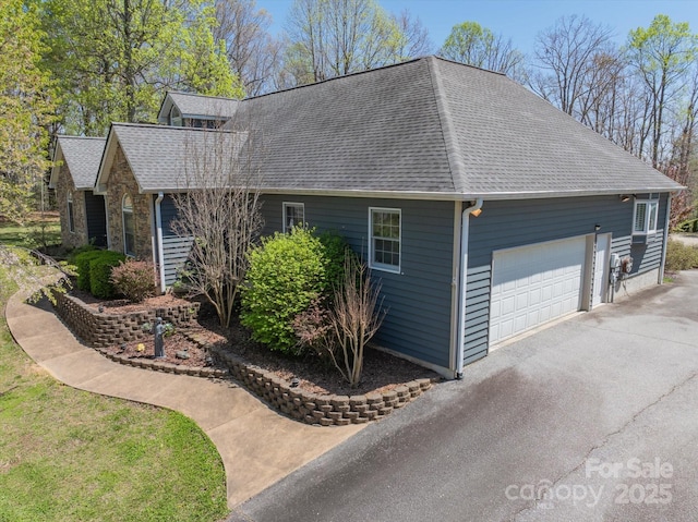 view of side of home featuring roof with shingles