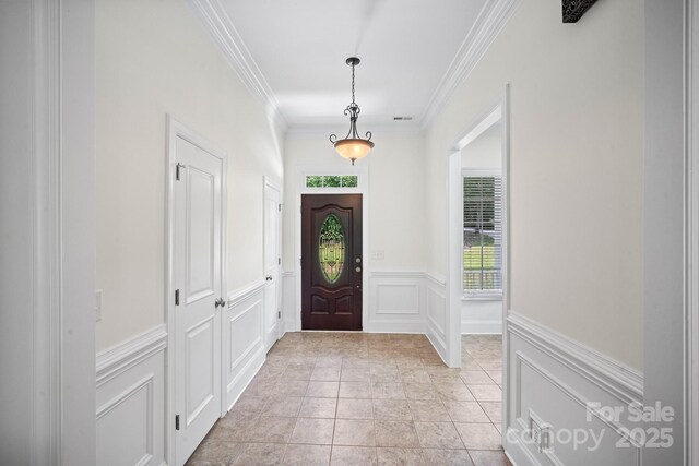 591 Emerald Isle Ct, Lexington, NC 27292 - foyer featuring ornamental molding, light tile patterned floors, wainscoting, visible vents, and a decorative wall